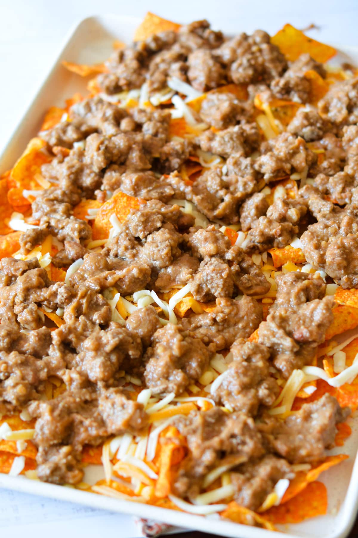 doritos with cheese, beef, and refried beans on top. 