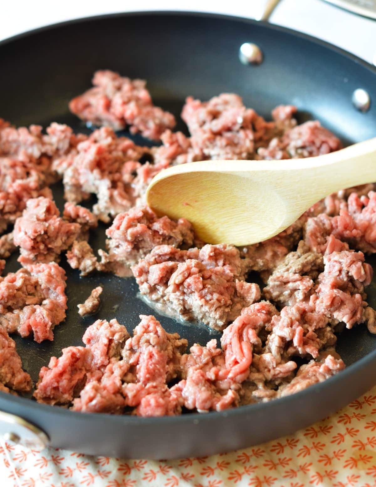 cooking ground beef in a skillet.