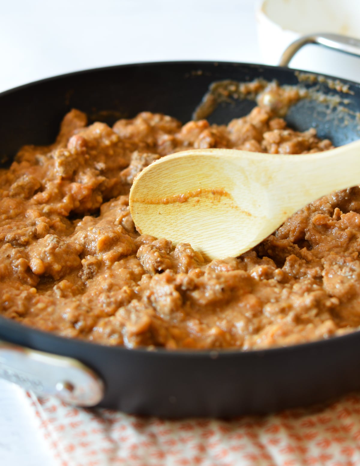 refried beans and ground beef in a skillet. 