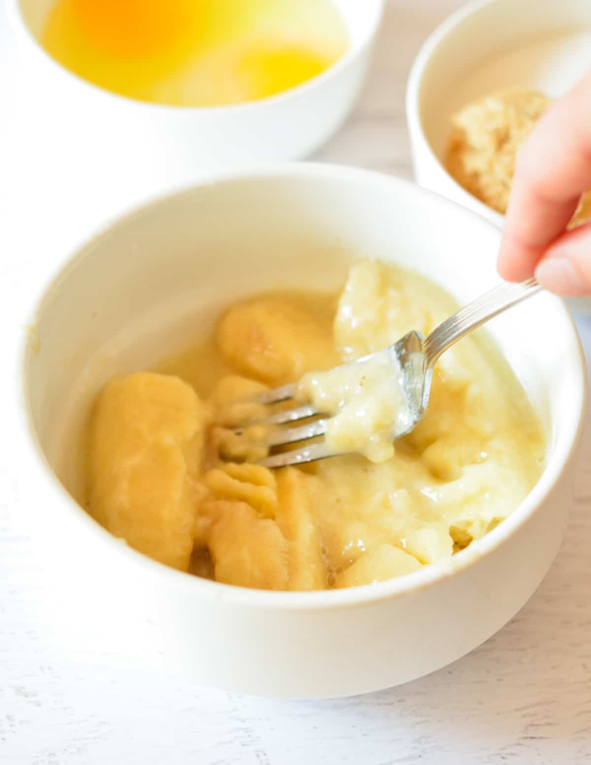 a fork mashing bananas.