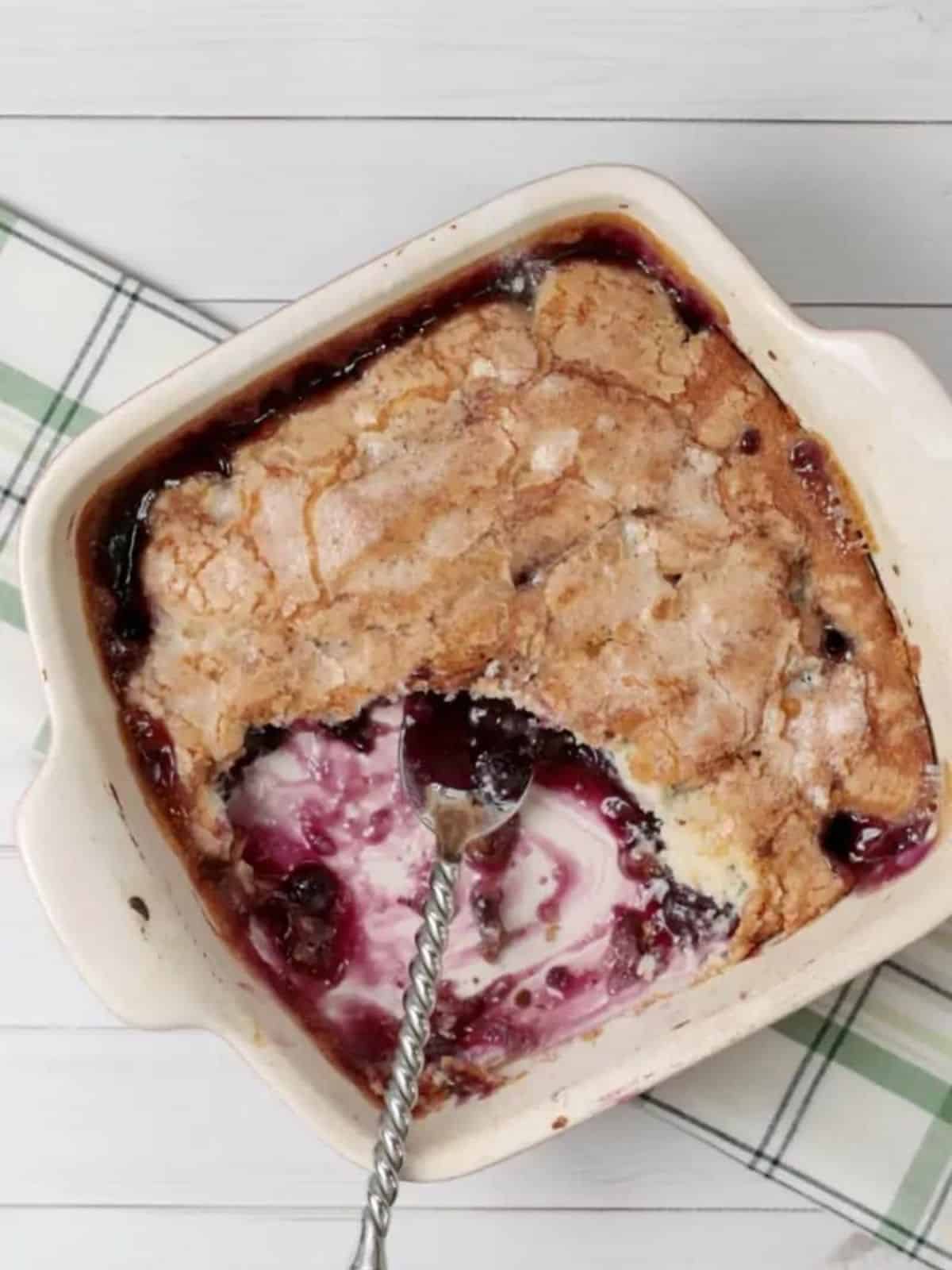 gluten free blueberry cobbler with a spoon in it.