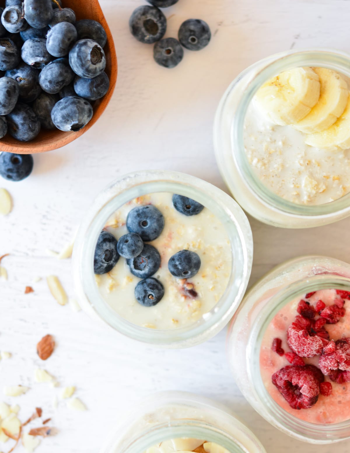 jars of overnight oats with fruit on them,