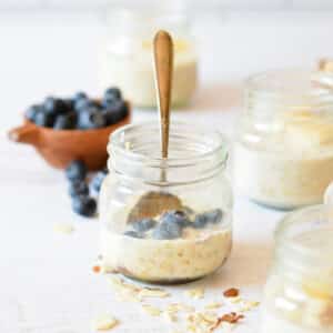 a jar of overnight oats with blueberries.