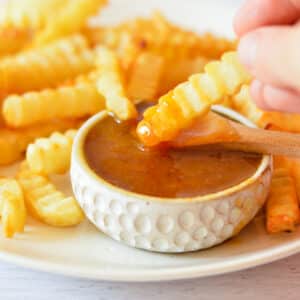 sweet and sour sauce with french fries.