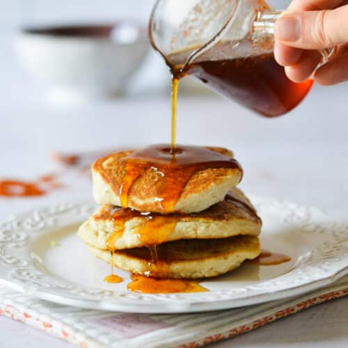 pouring spicy maple syrup on pancakes.