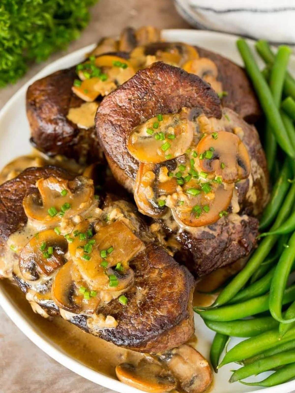 steak with mushrooms and green beans.