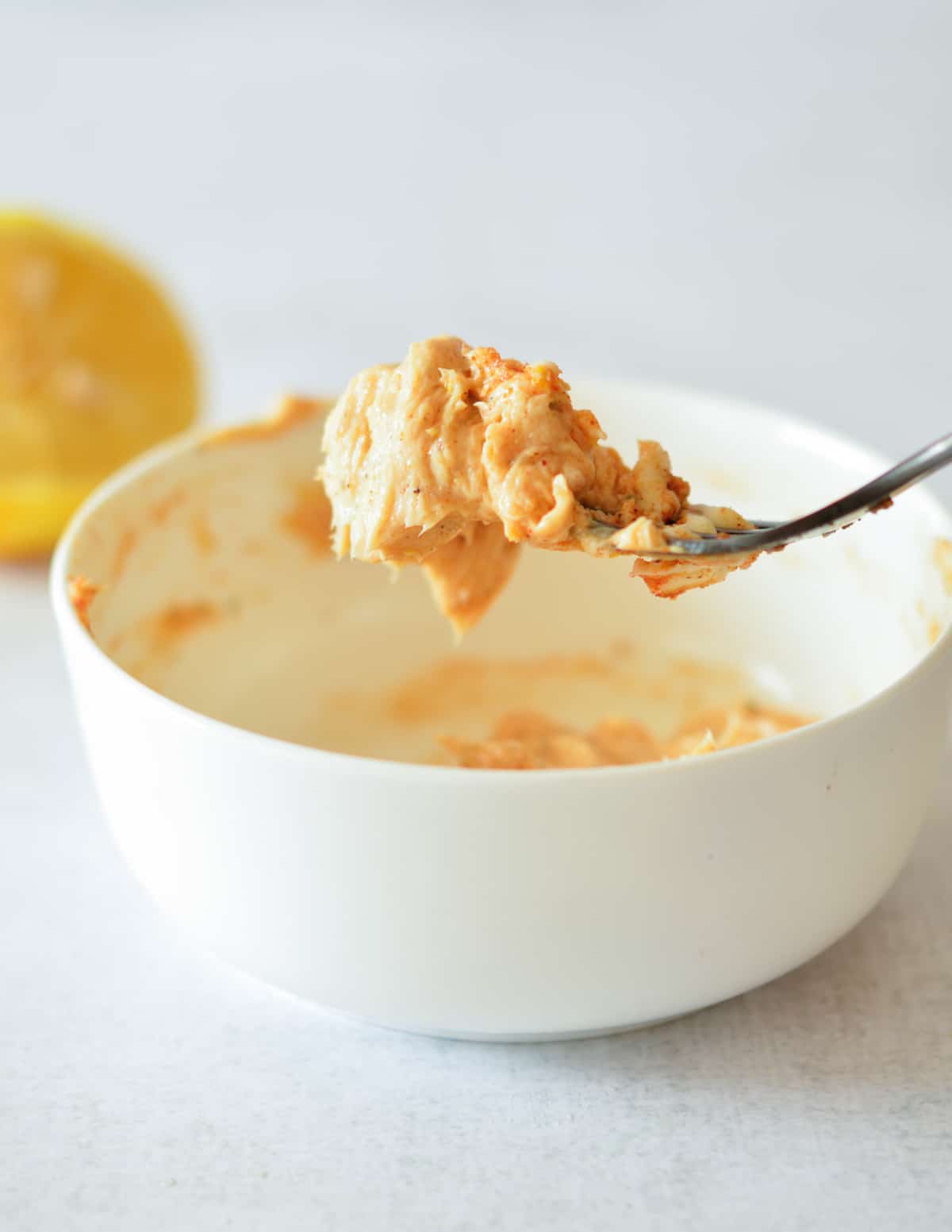 a forkful of cajun butter over a bowl.