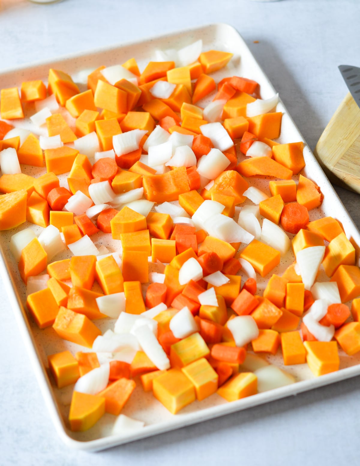 butternut squash, onion, and carrots on a sheet pan.