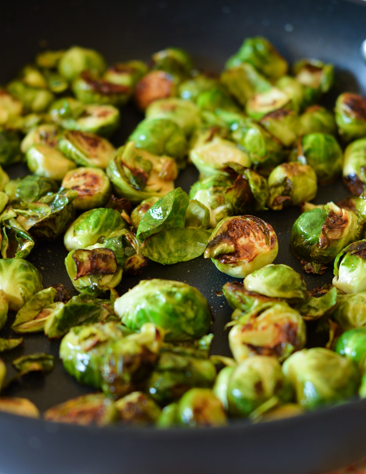 close up of caramelized brussels sprouts in a skillet.
