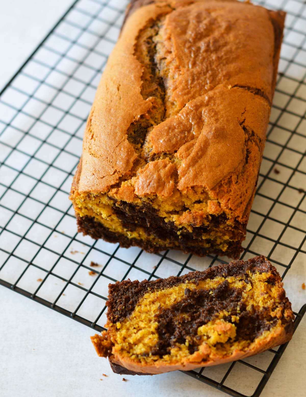 a slice of pumpkin bread on a wire rack.