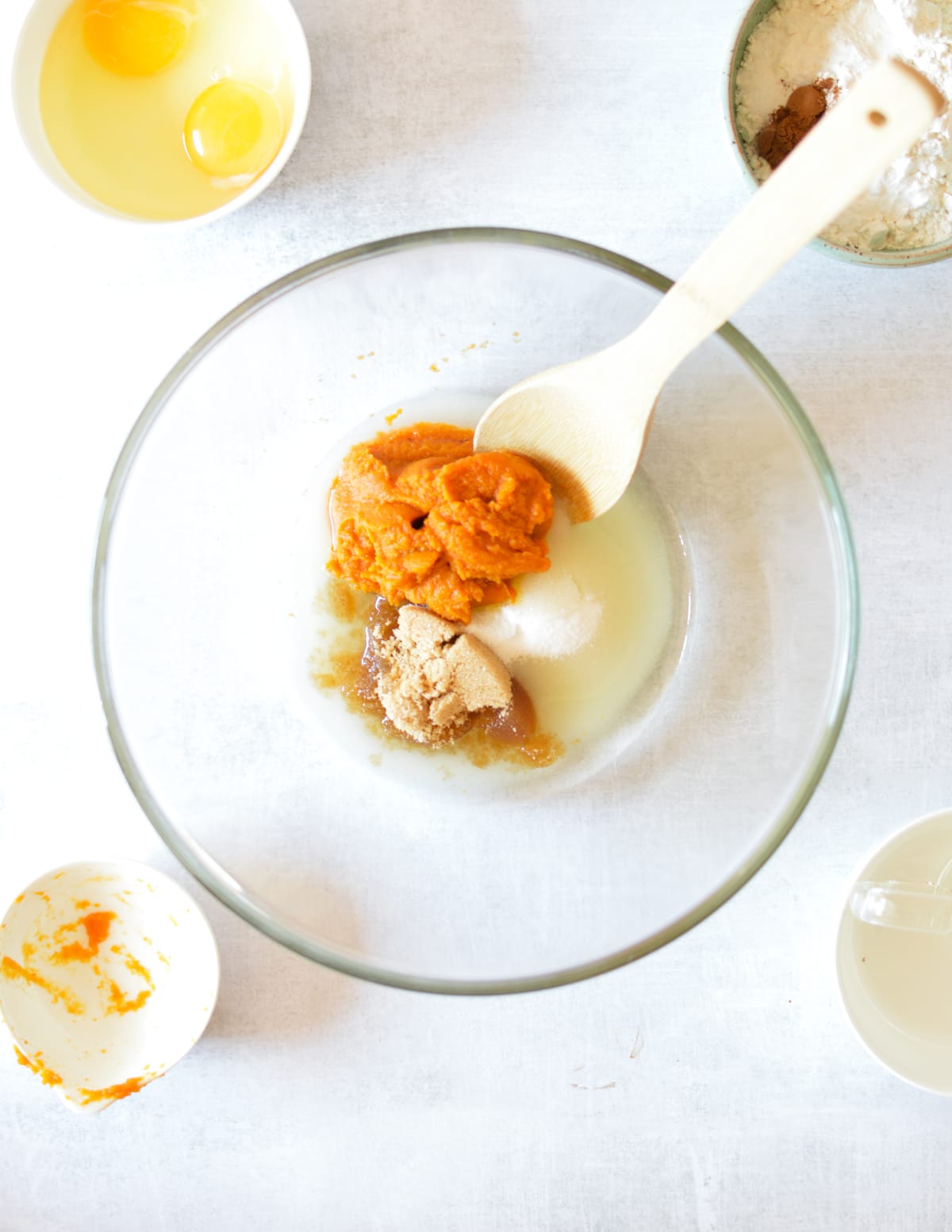 a bowl of pumpkin, sugar, brown sugar, and oil.