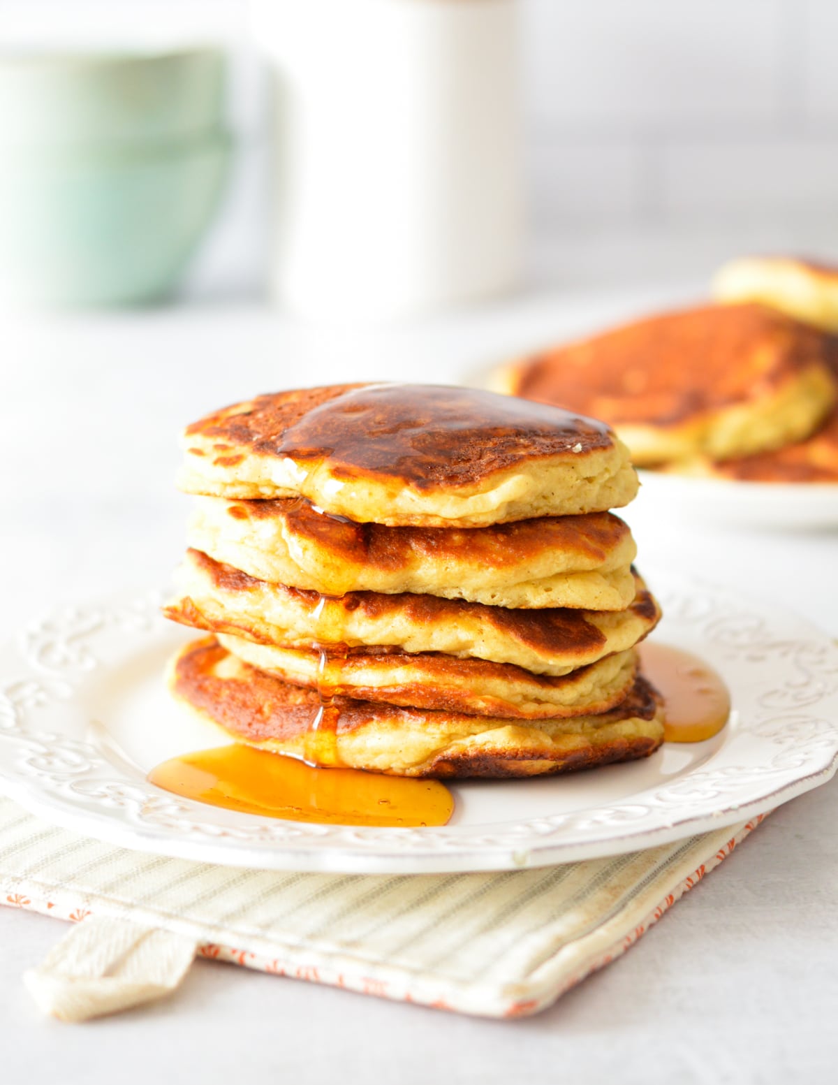 a stack of pancakes with maple syrup dripping down them.