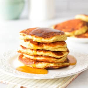 a stack of pancakes with maple syrup.