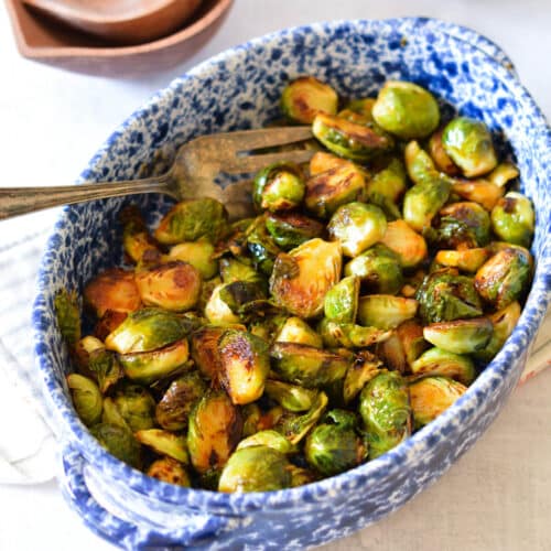 a serving dish with brussels sprouts in it.