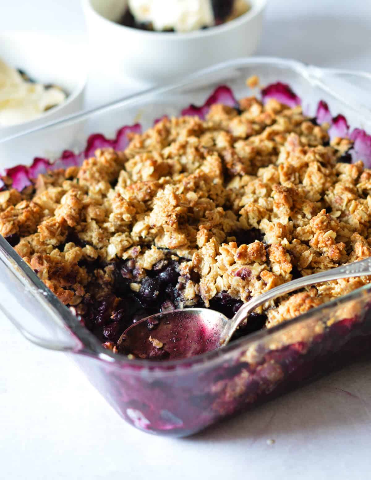 blueberry crisp with a spoon in it. 