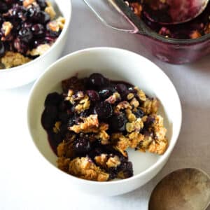 a bowl of blueberry crisp