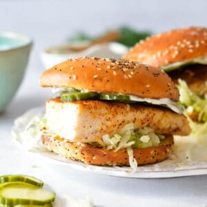 mahi mahi sandwich with pickles and mayo.