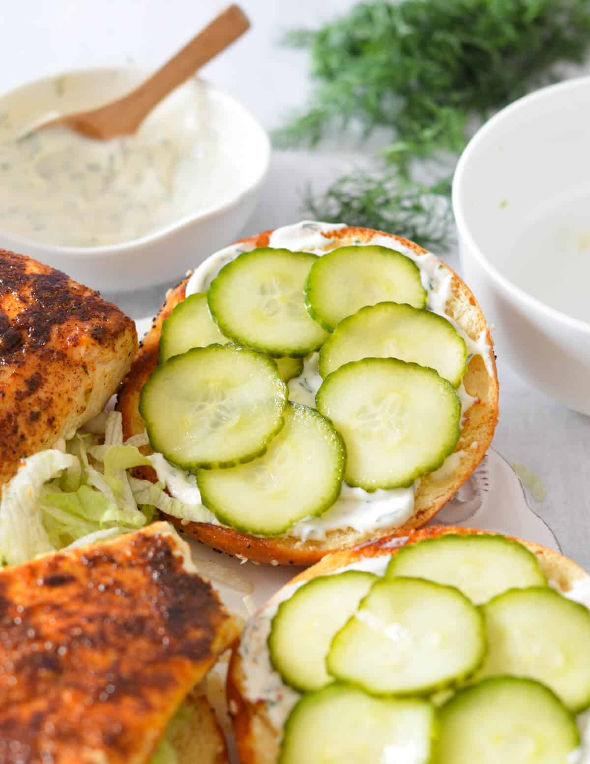 toasted bun with lemon aioli and pickles on top. 