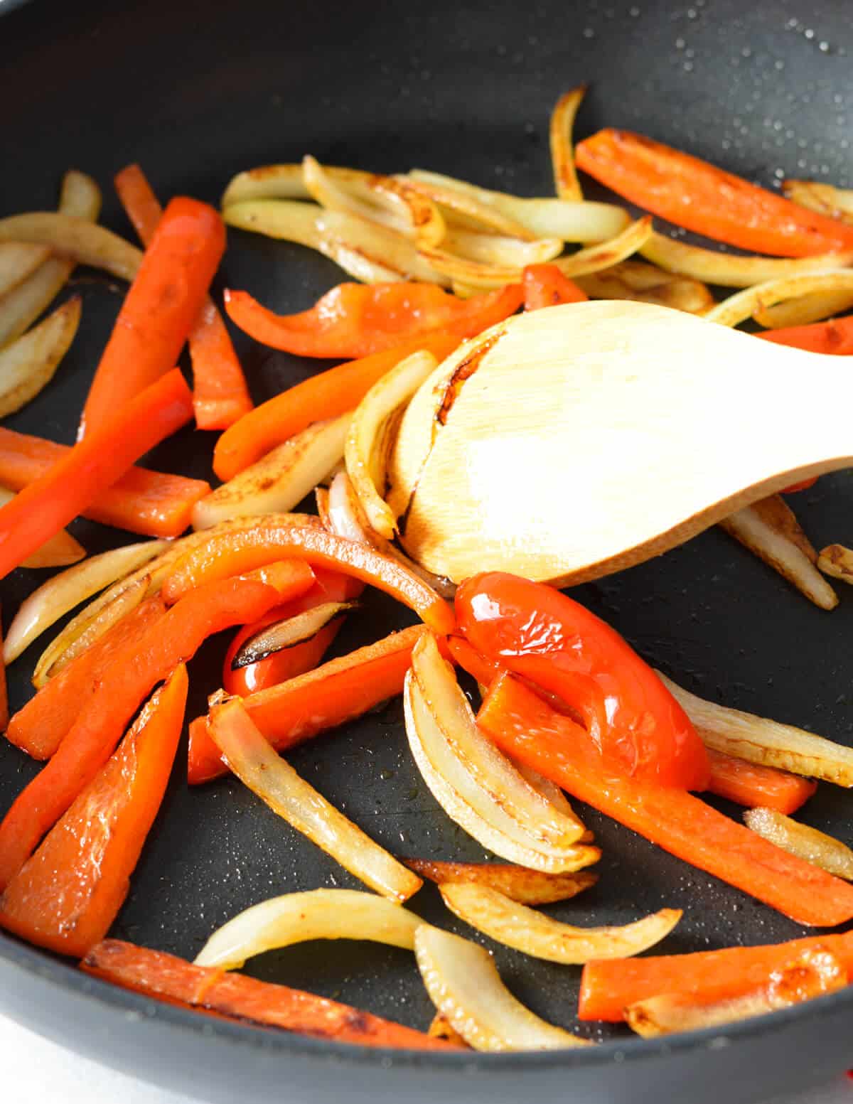 caramelized onions and peppers in a skillet.