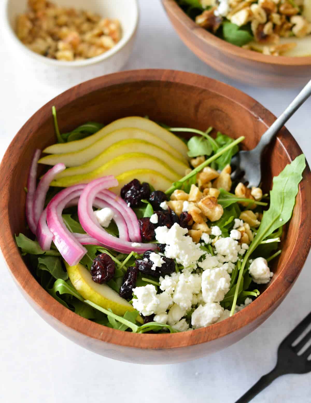 arugula salad with pears, goat cheese, onions, and cranberries. 