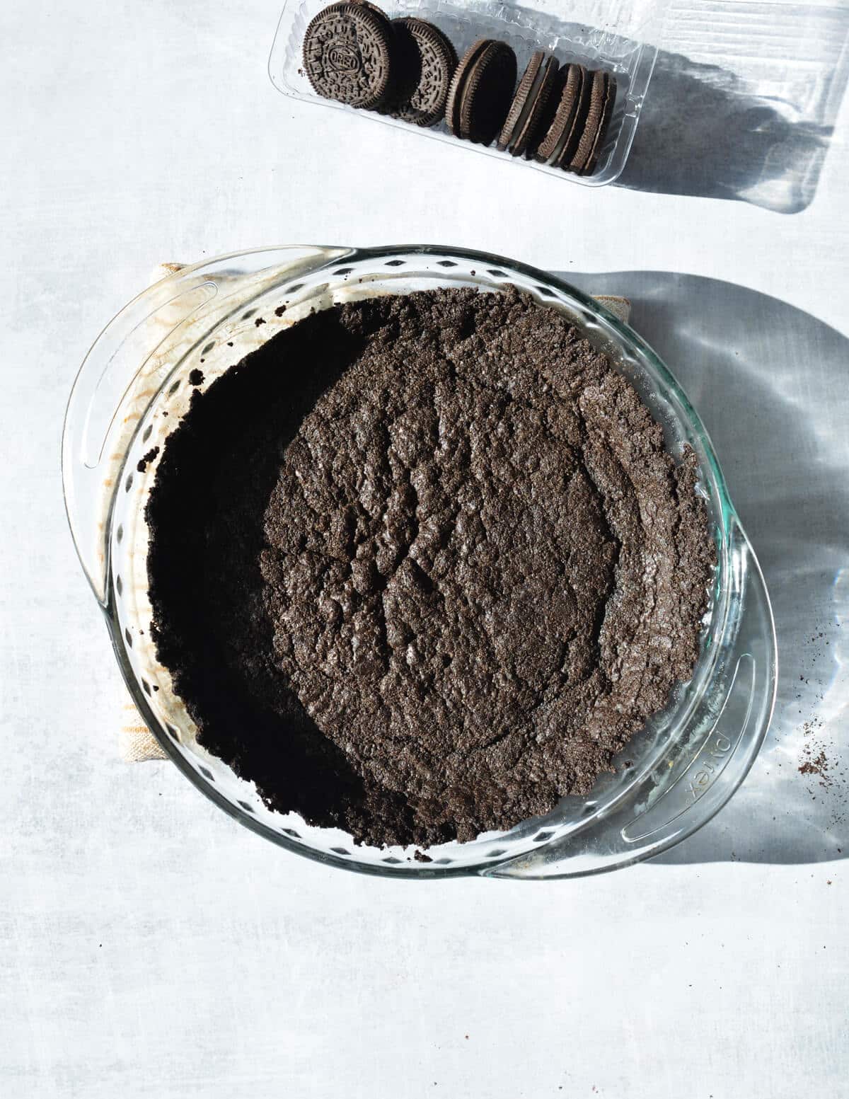 baked chocolate cookie crust in pie pan. 