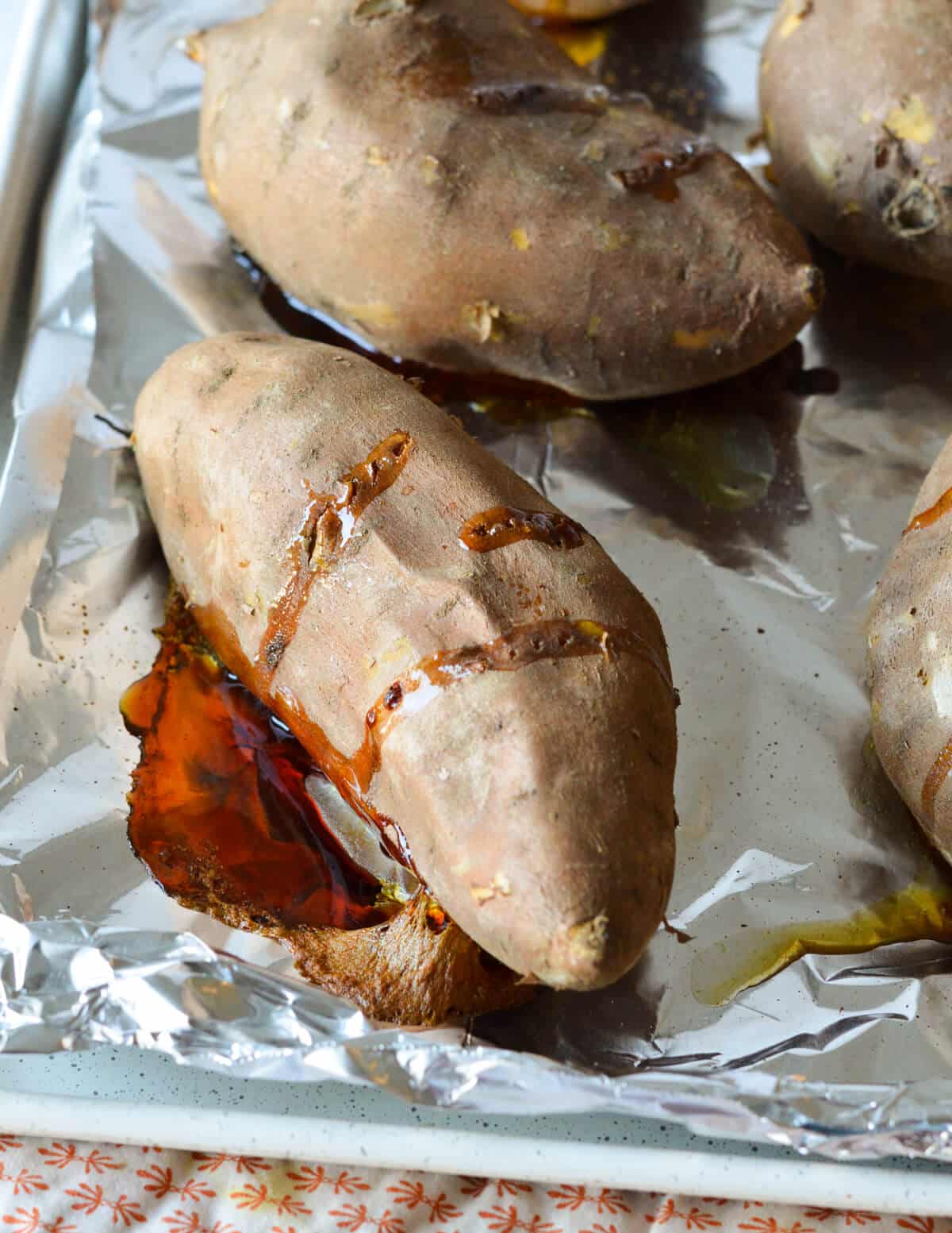 cooked sweet potatoes on a sheet pan with aluminum foil. 