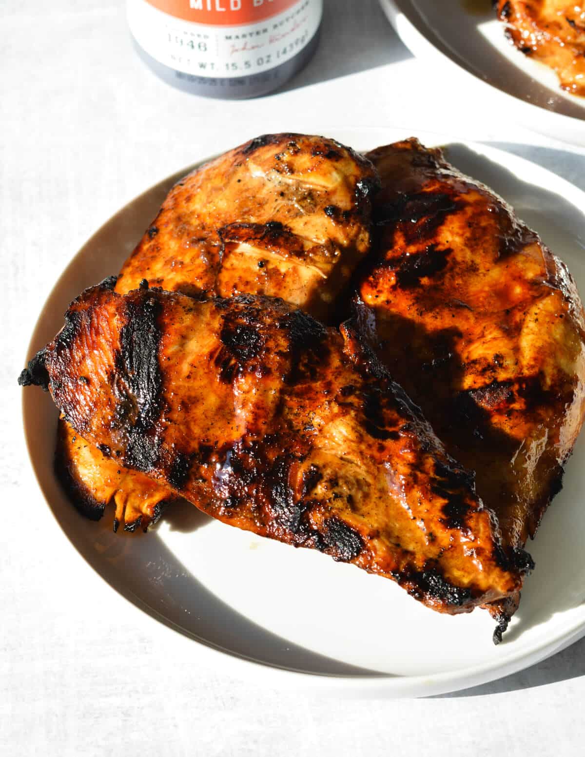 grilled chicken on a white plate. 