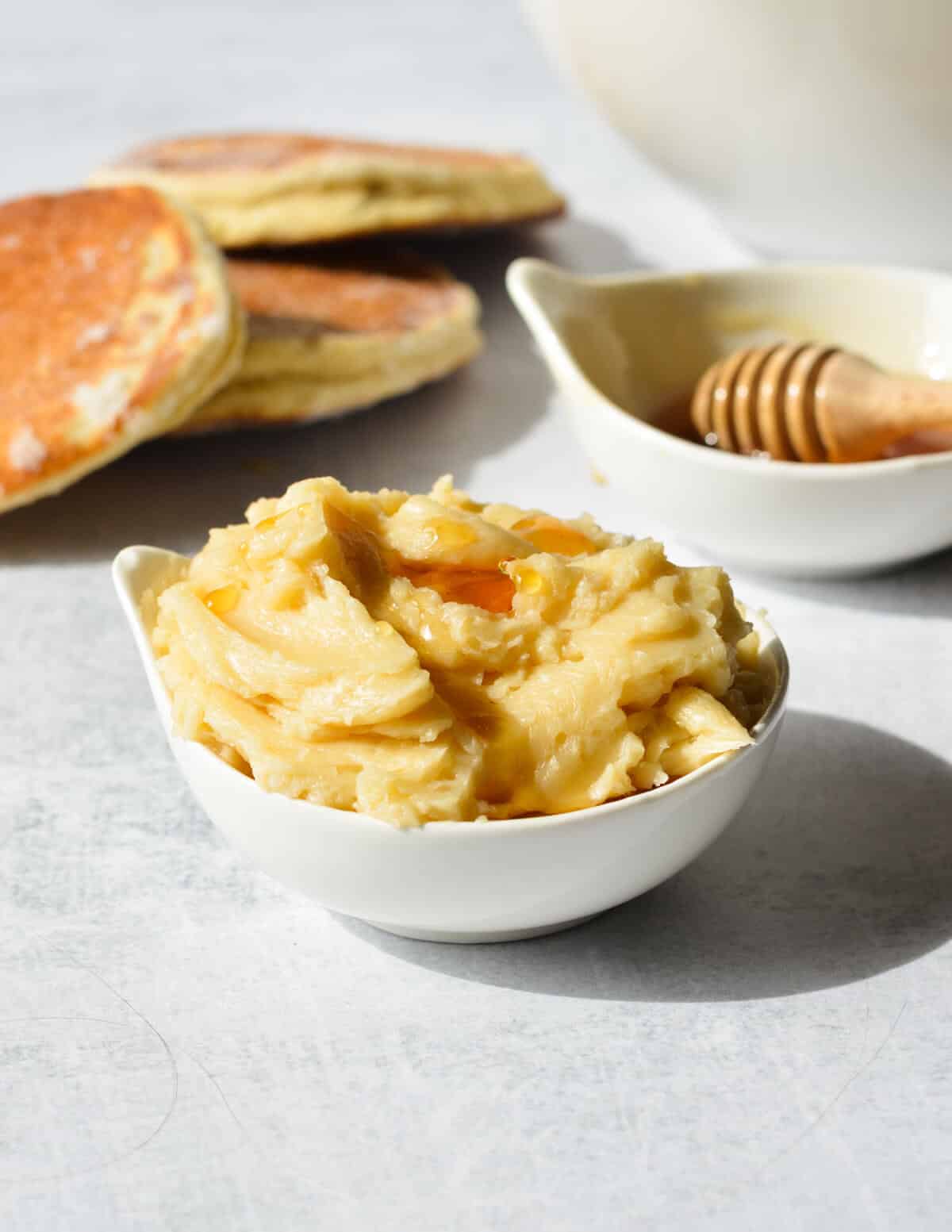 a small bowl of honey butter with honey on top.