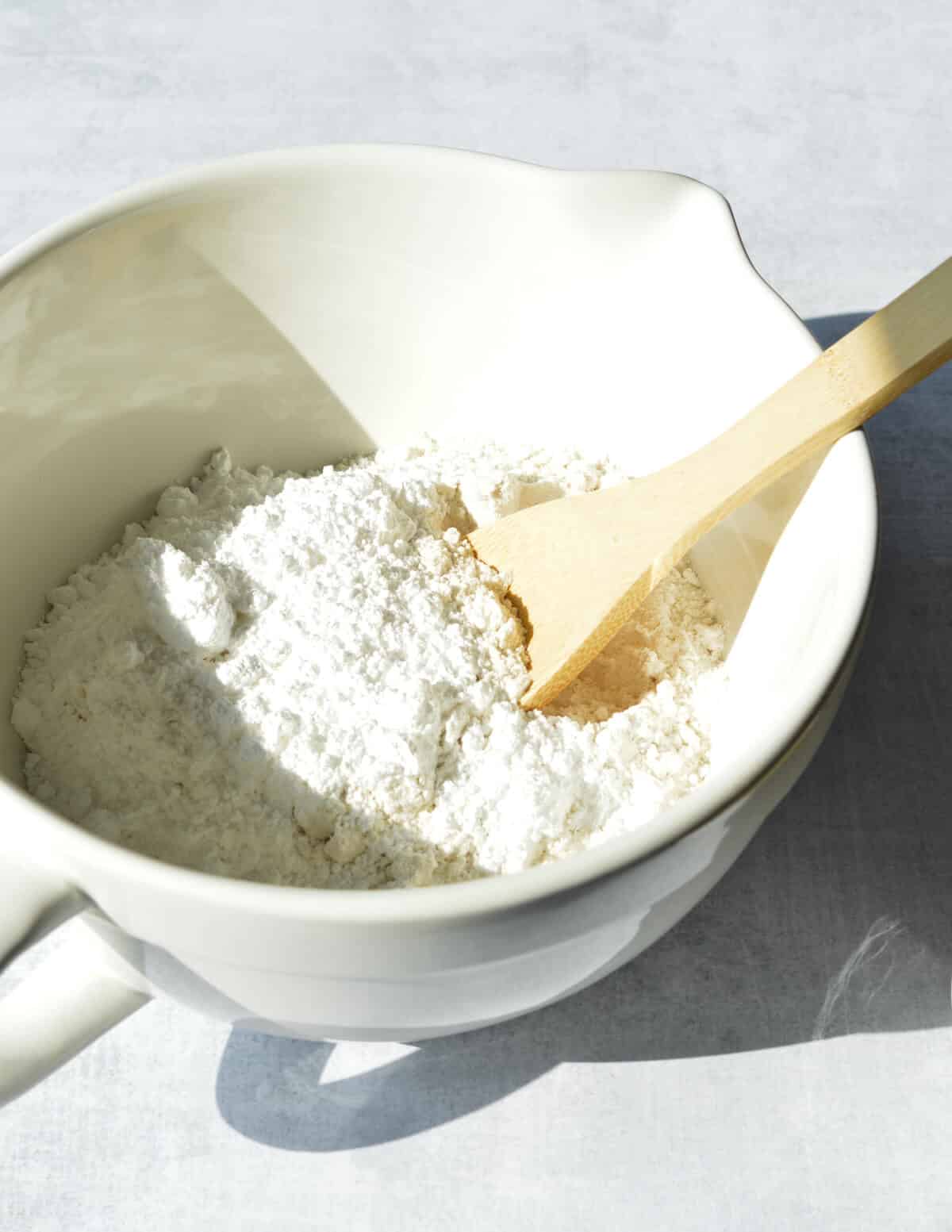 stirring flour and sugar together in a bowl.