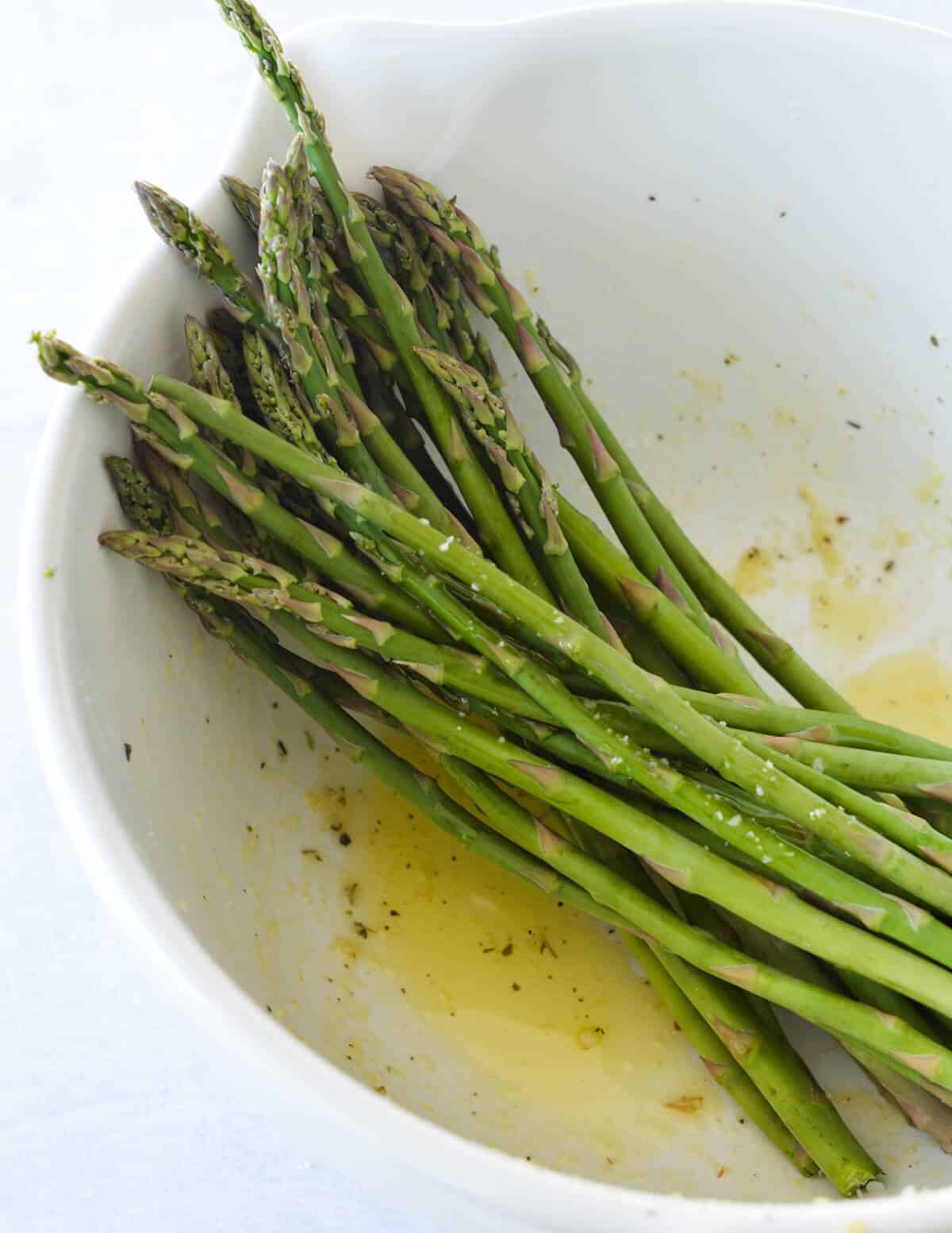 a bowl of asparagus in olive oil. 