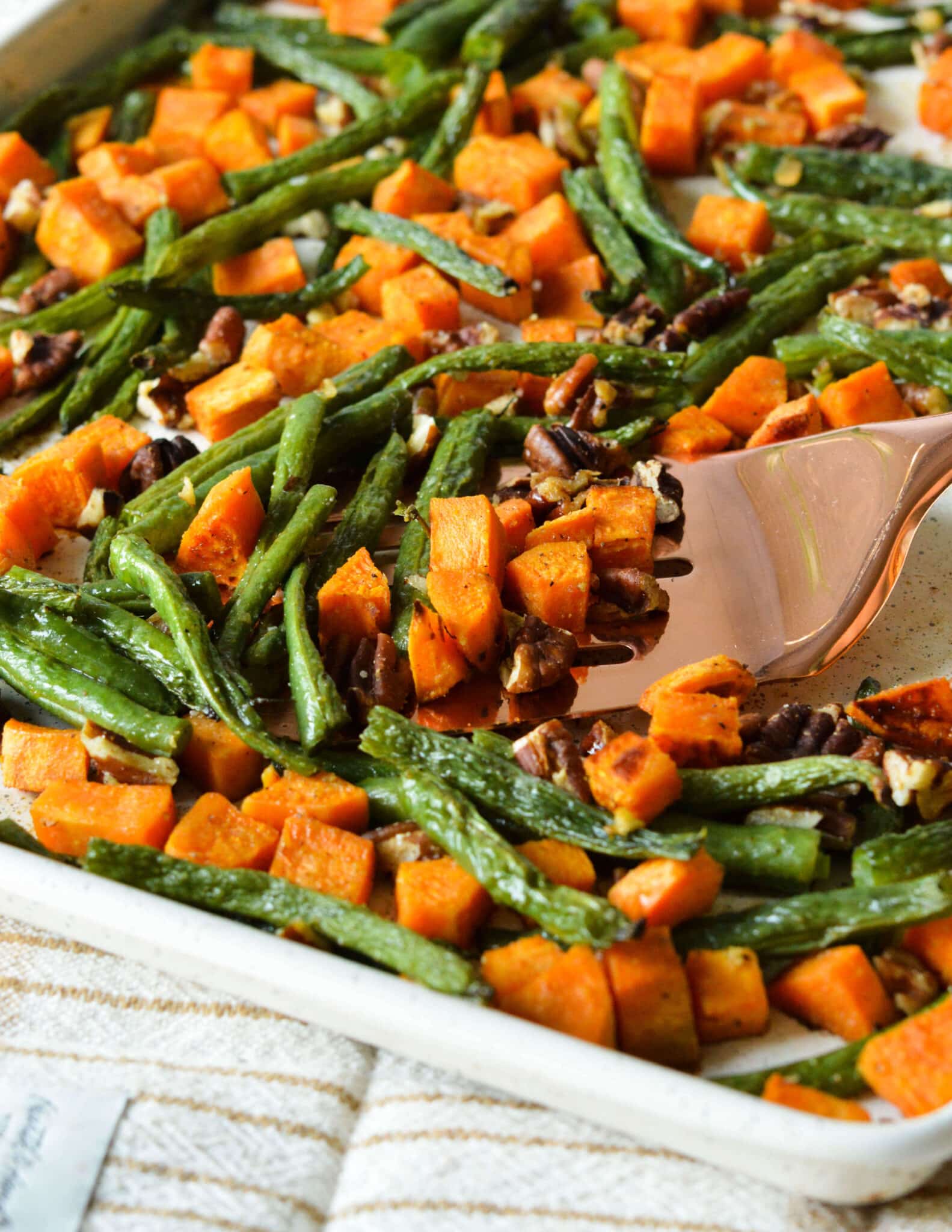 roasted green beans and sweet potatoes on a sheet pan.