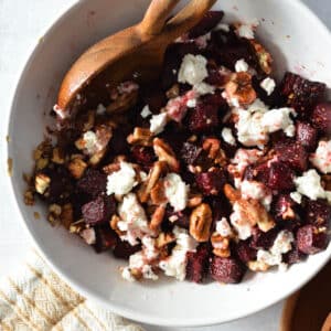 a bowl of roasted beets, goat cheese, and roasted pecans.