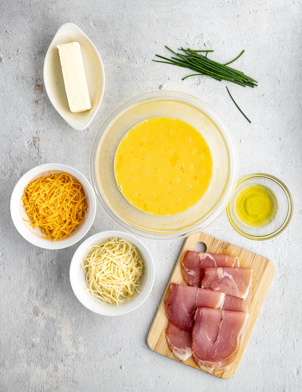 butter, chives, eggs, cheese, olive oil, prosciutto