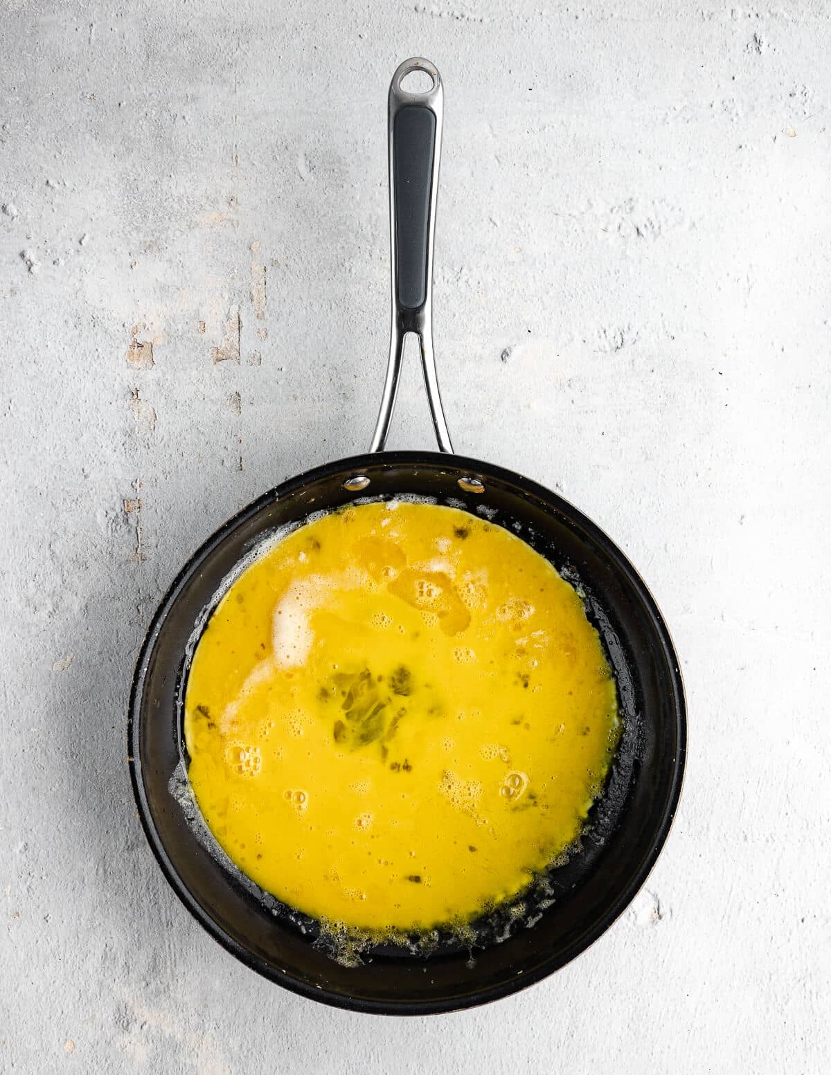 raw scrambled eggs in a skillet.