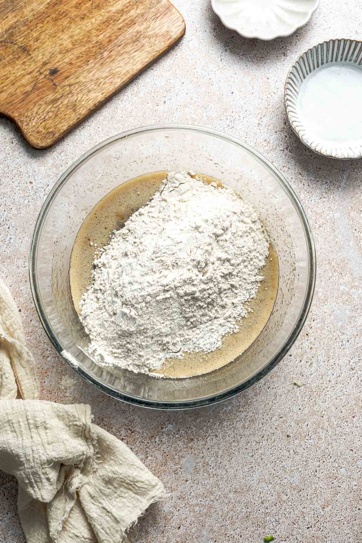 all-purpose flour on top of whisked eggs and sugar in a bowl. 
