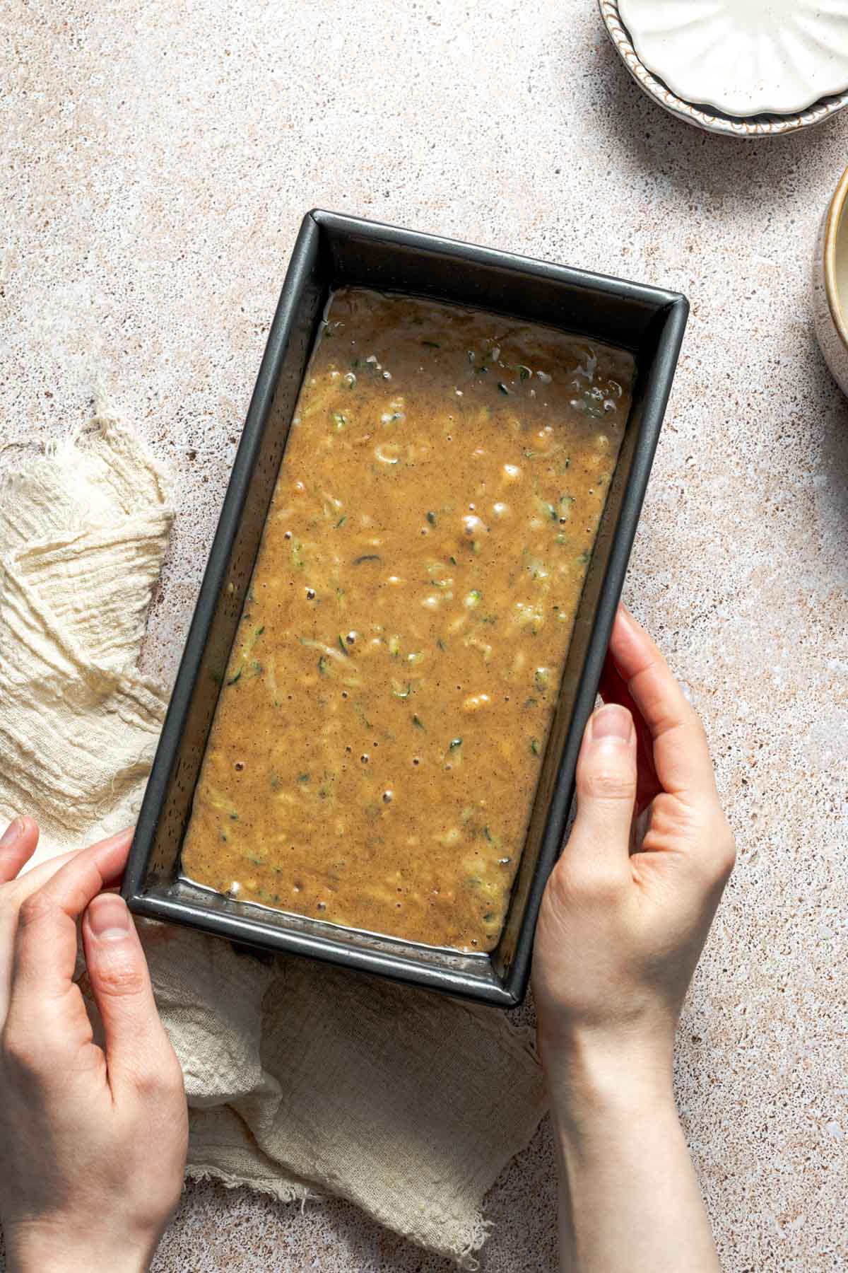 zucchini bread batter in a loaf pan.