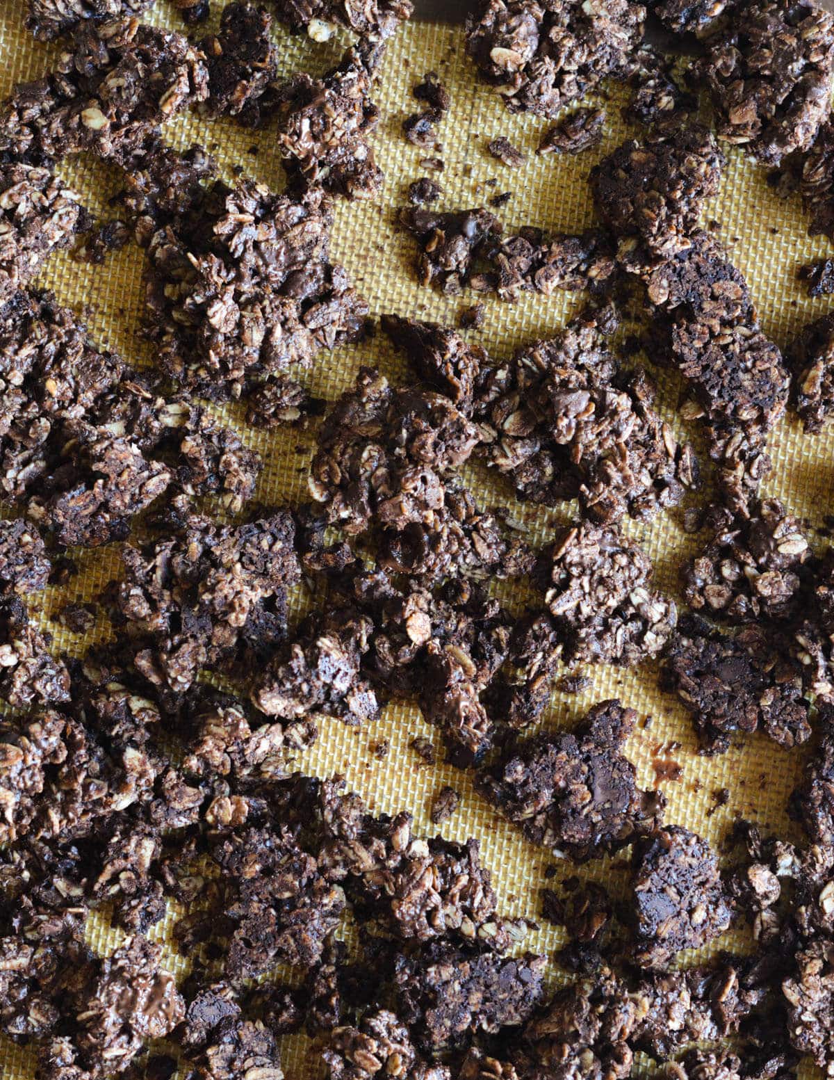 chocolate granola clusters on a sheet pan.