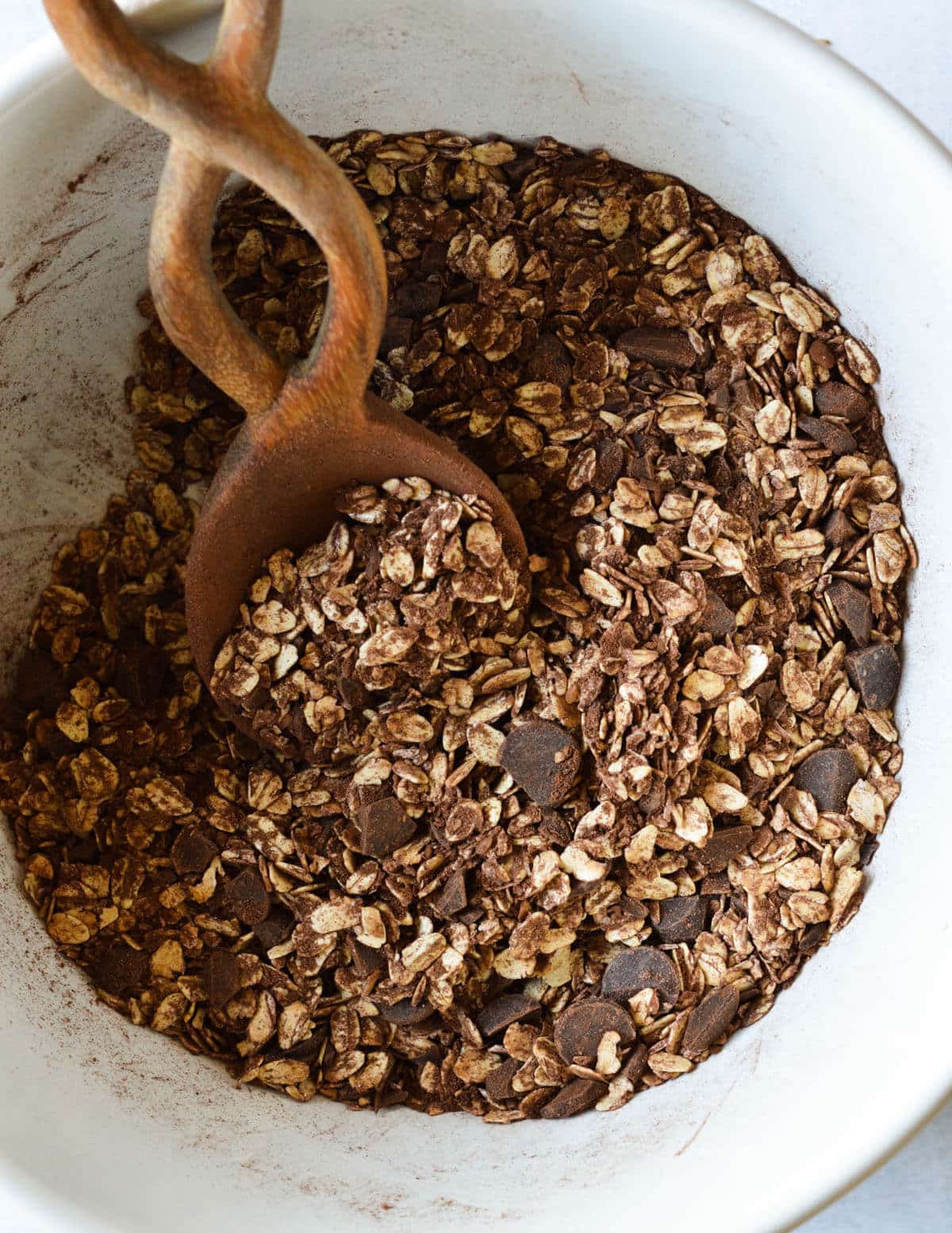 oats mixed with cocoa powder, dark chocolate, and flax meal in a large bowl.