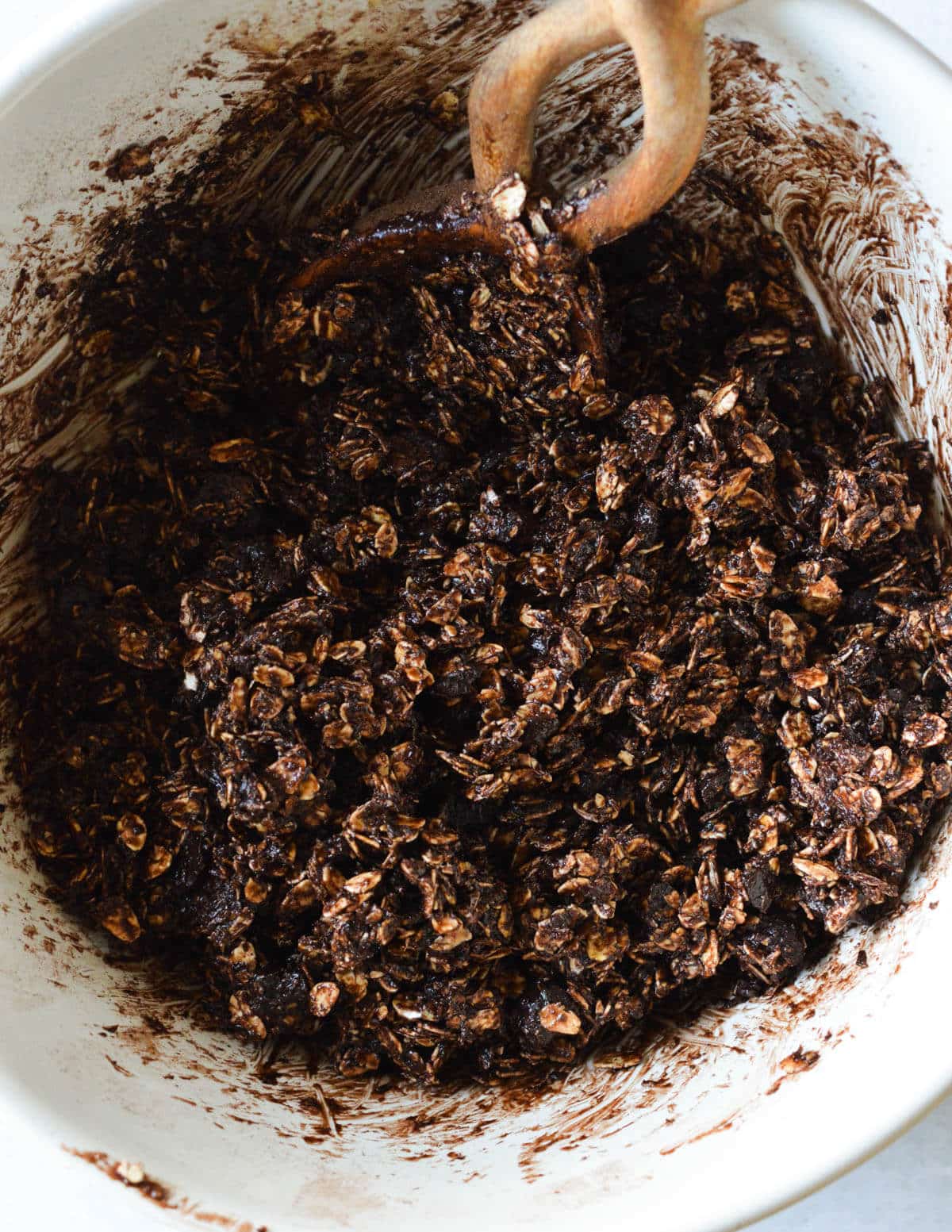 wet chocolate granola mixture in a bowl.