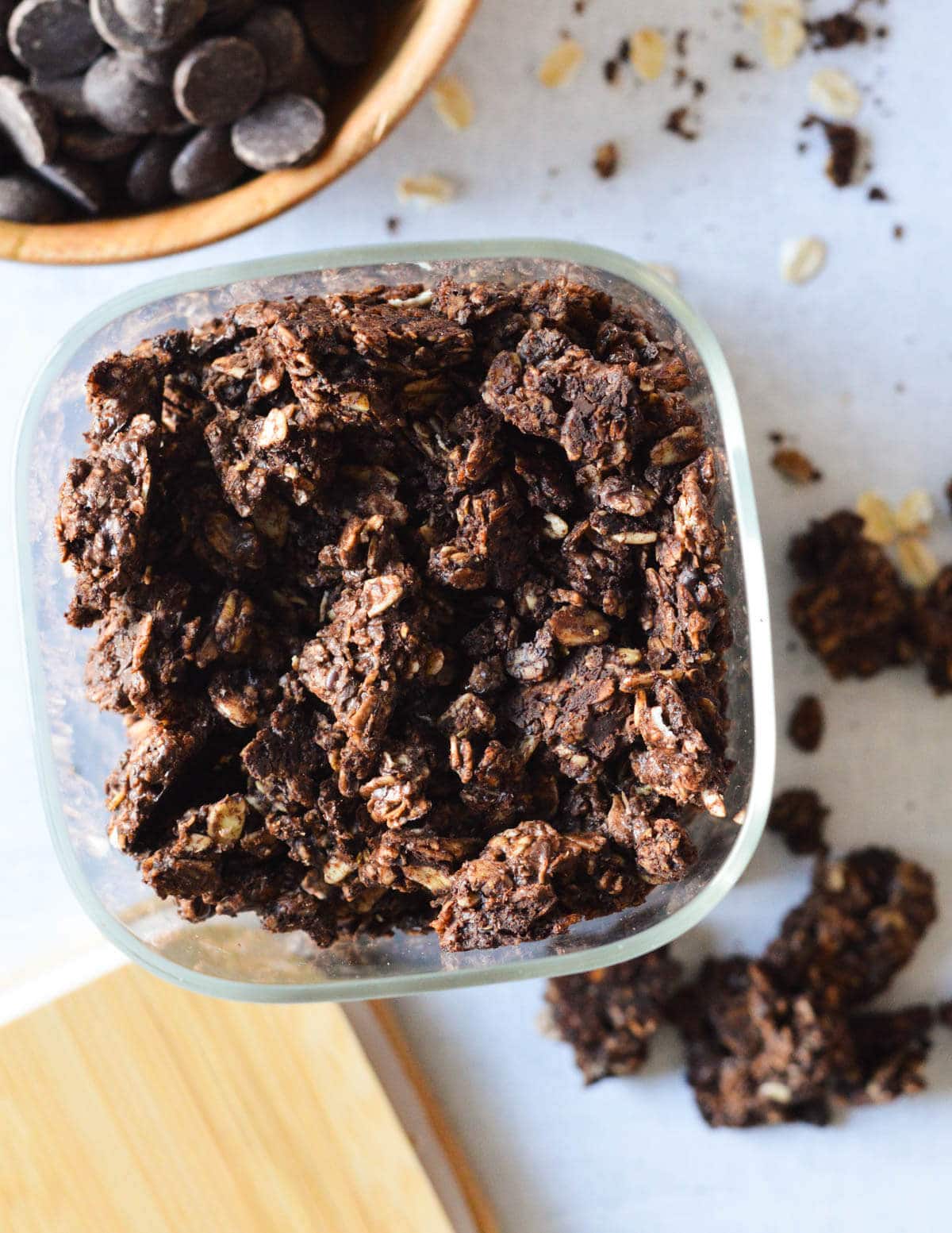 chocolate granola in a glass storage dish.