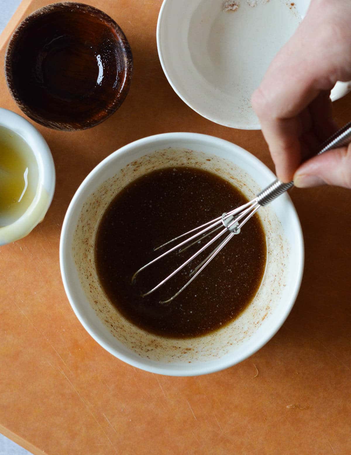 a small bowl of honey, olive oil, cinnamon, and butter whisked together.
