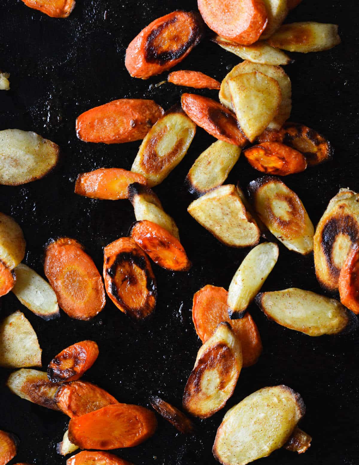 caramelized carrots and parsnips on a sheet pan.