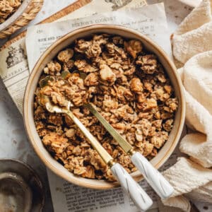 a bowl of maple walnut granola with spoons in it.