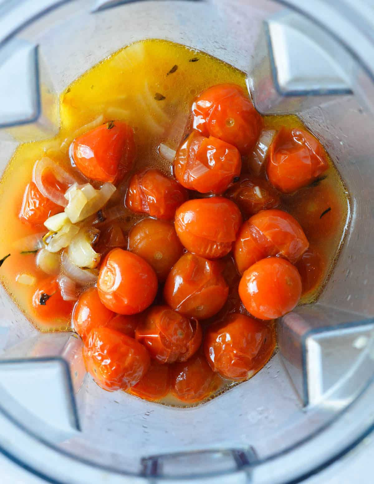 roasted cherry tomatoes and vegetable stock in a blender.
