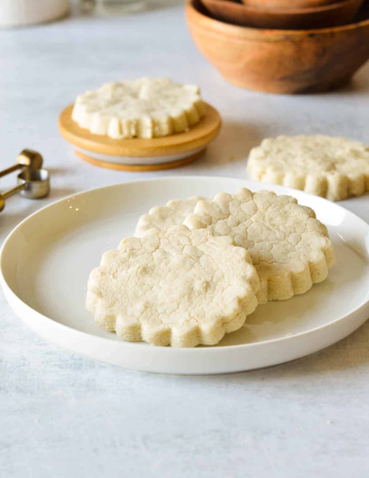 a plate with three gluten free shortbread cookies on it.