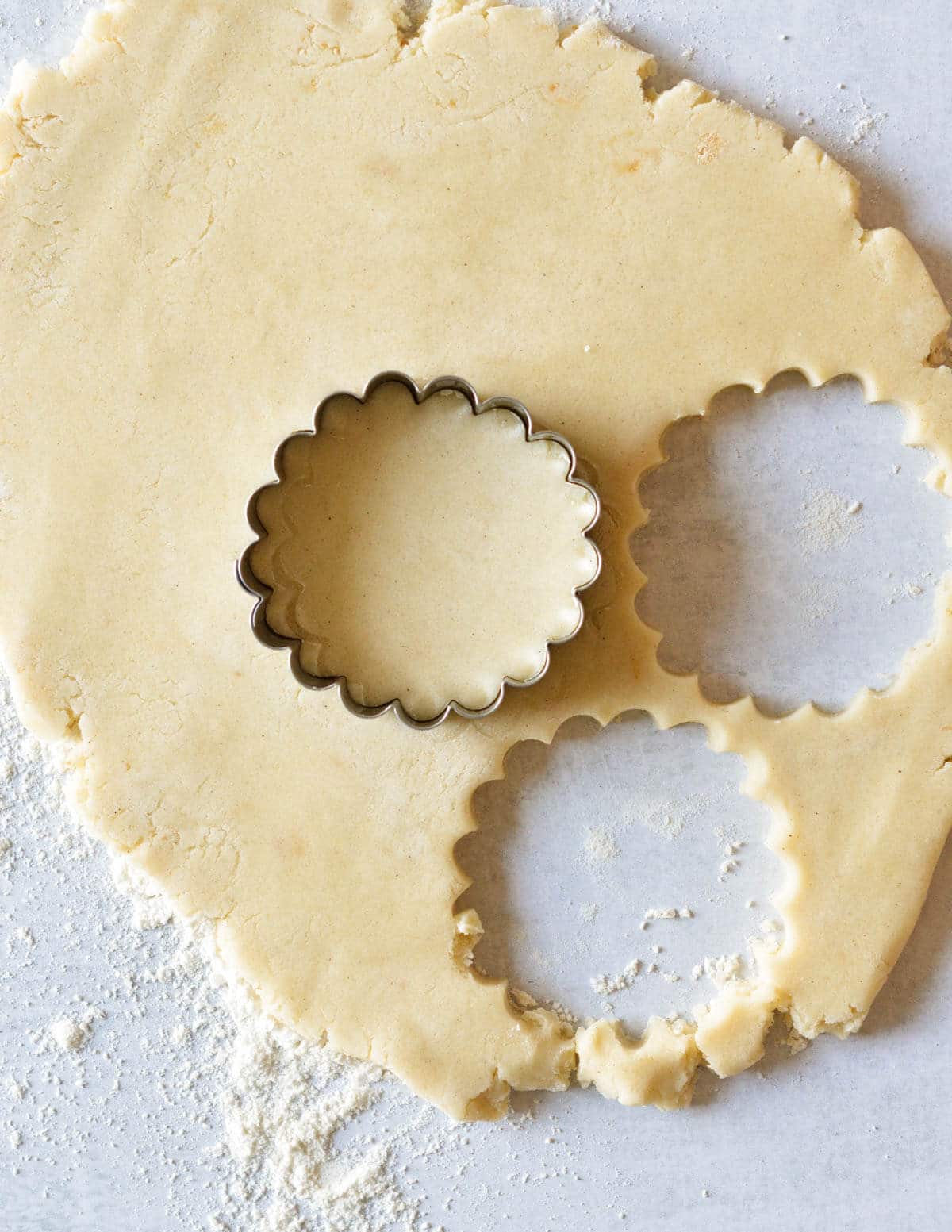 gluten free shortbread dough rolled out and cut with a round cookie cutter.