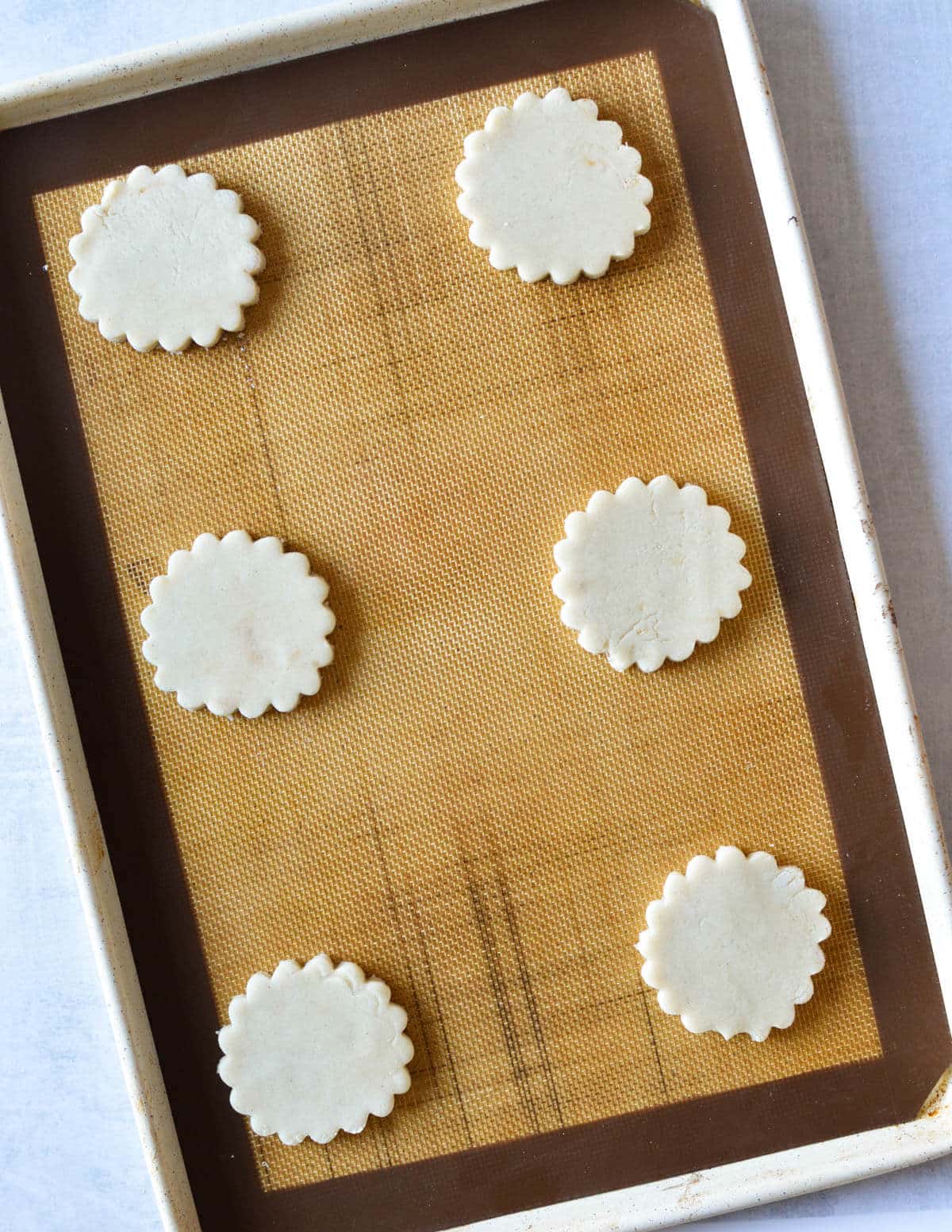 unbaked gluten free shortbread cookies on a sheet pan.