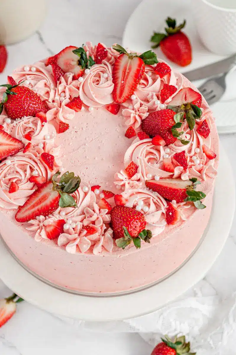 top of a gluten free strawberry cake with strawberries on top. 