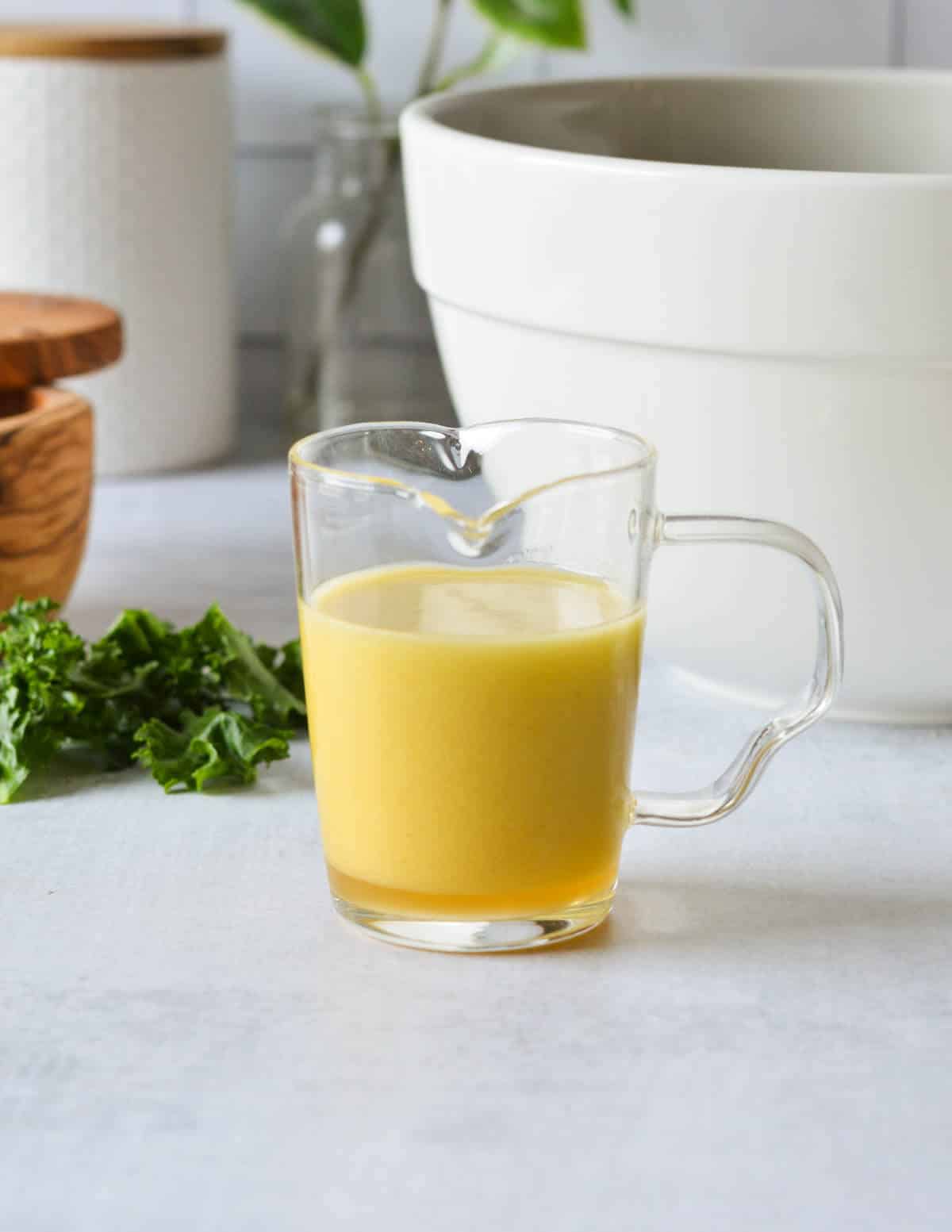 apple maple vinaigrette in a glass cup.
