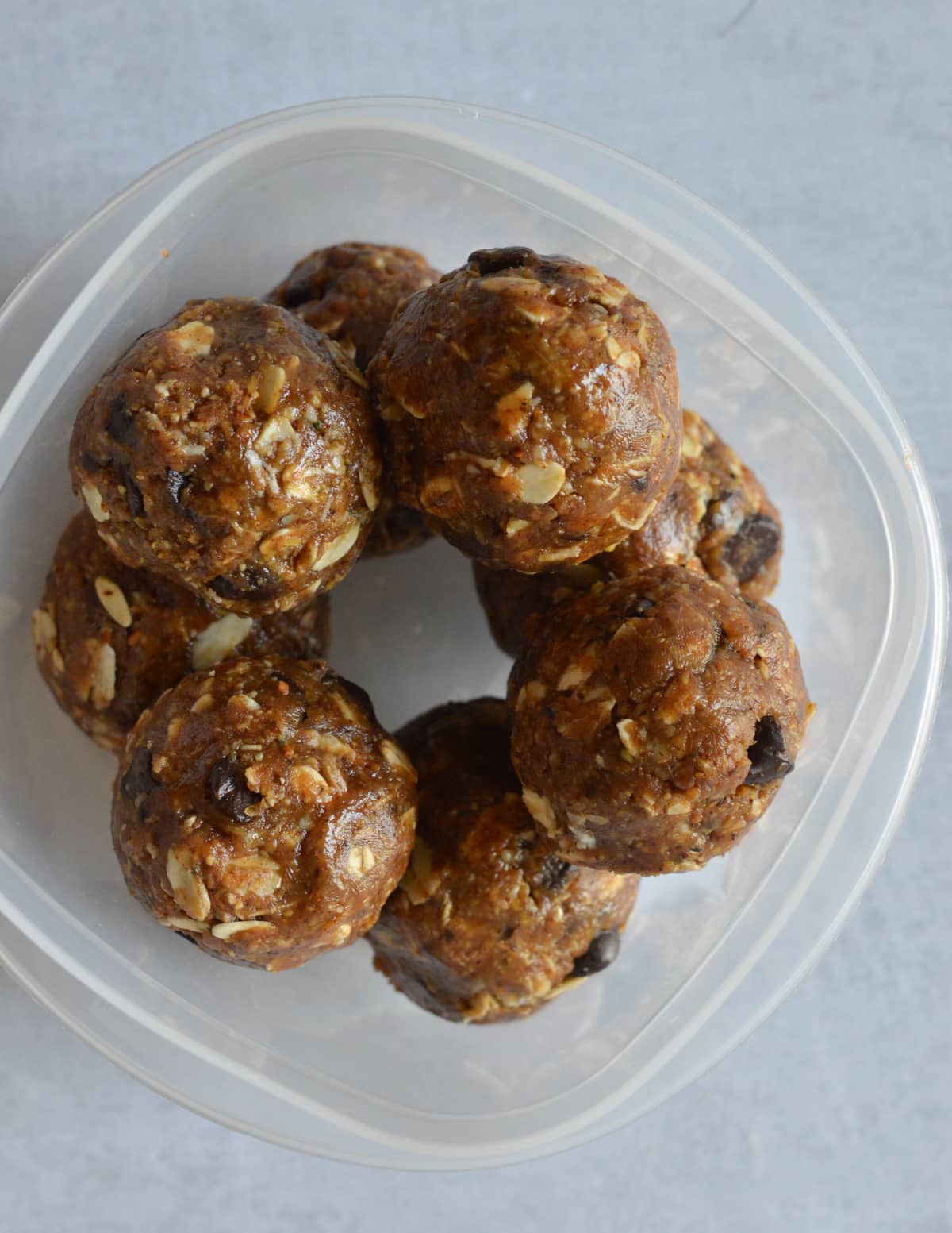 a container with almond butter protein balls in it.